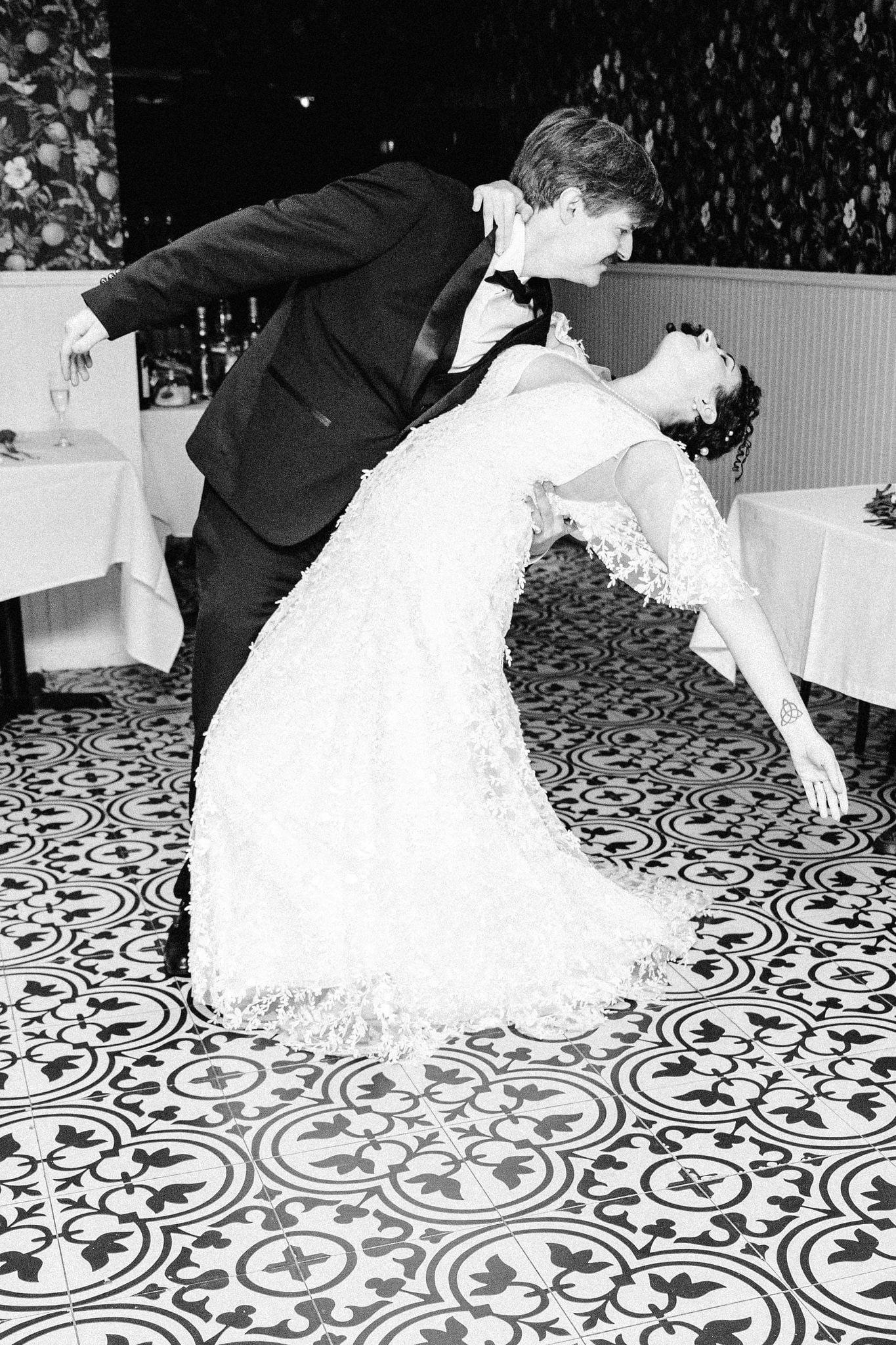 First-dance dip on patterned tile, black and white