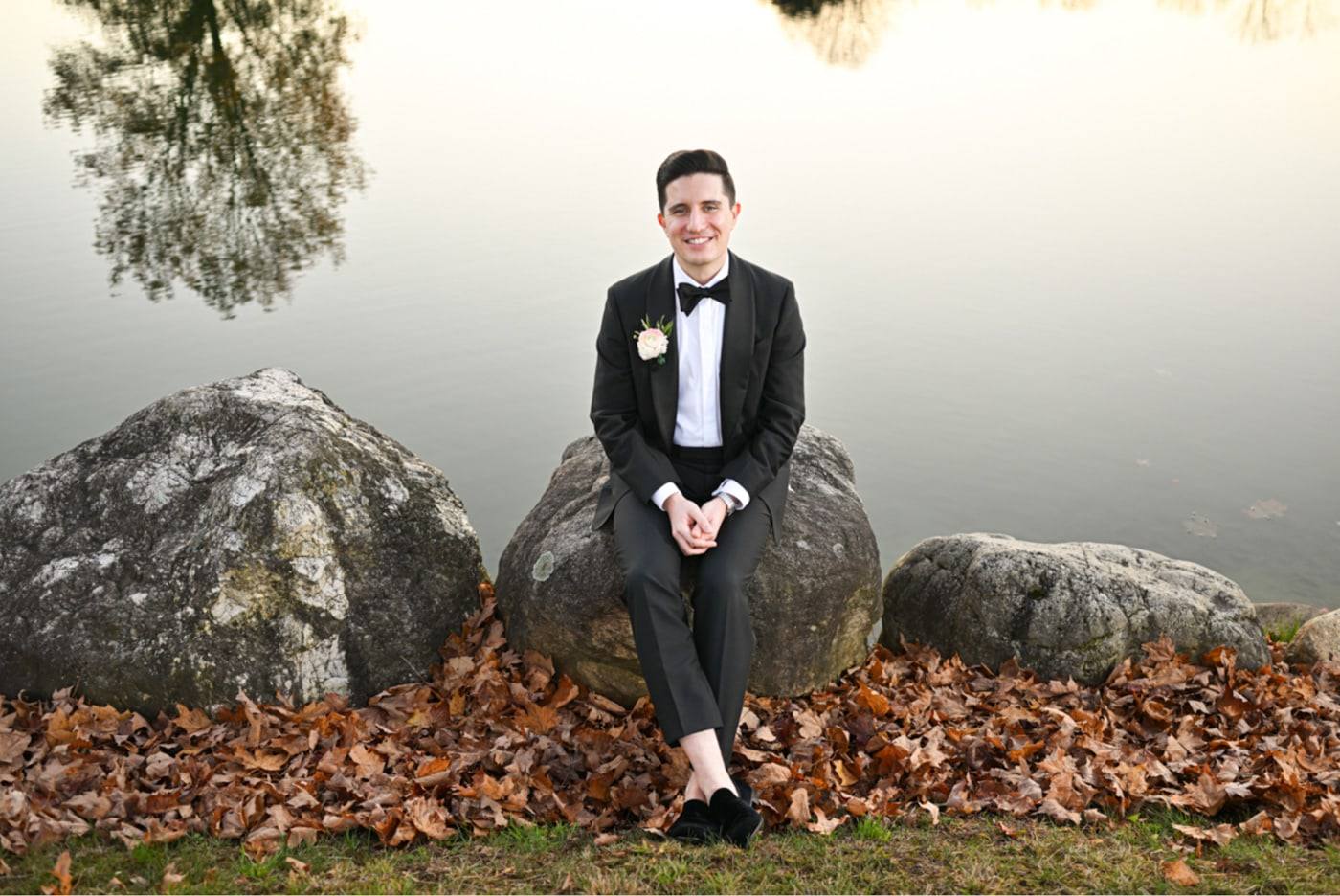 Groom on a boulder in the fog