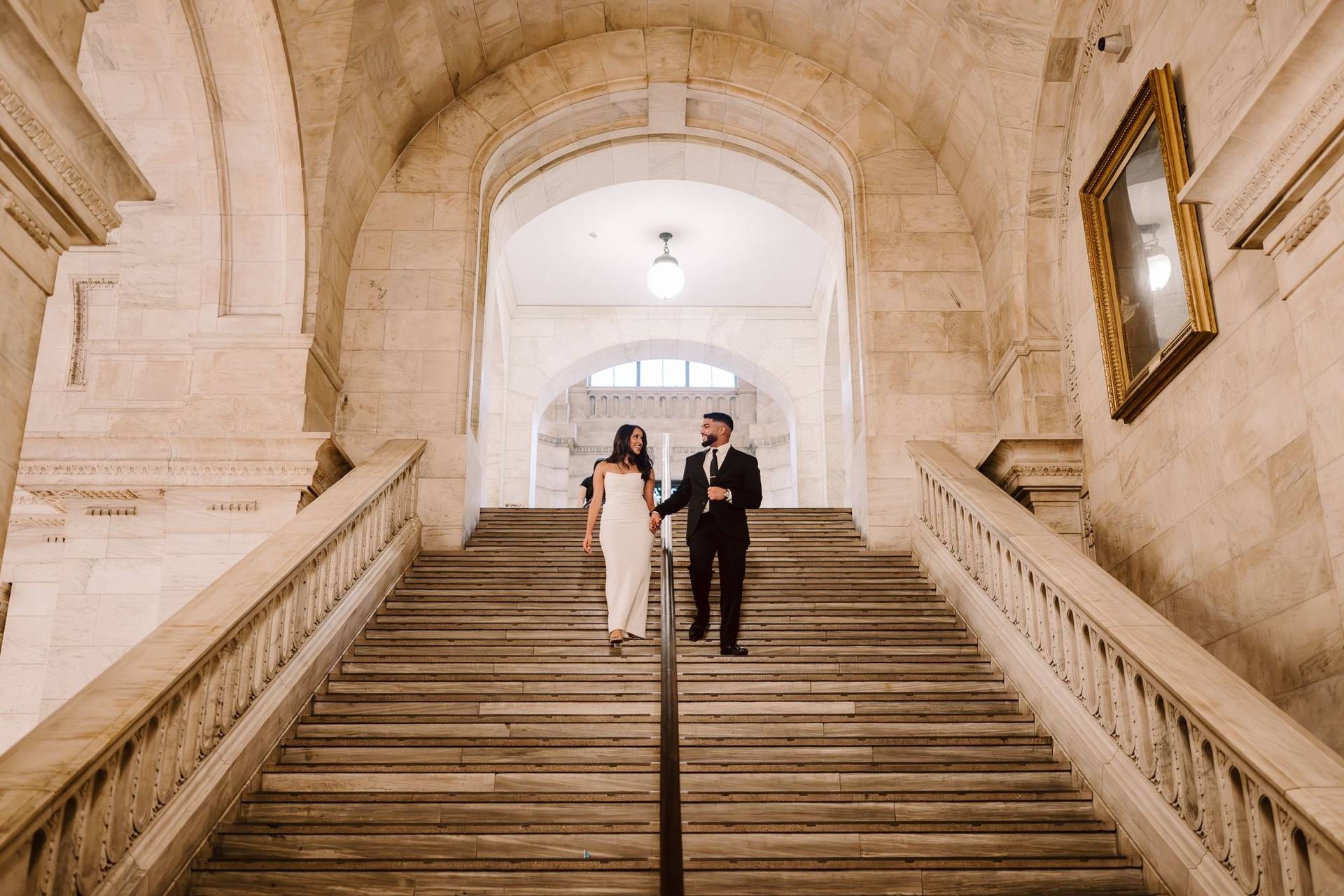 Small couple on a sweeping stone staircase