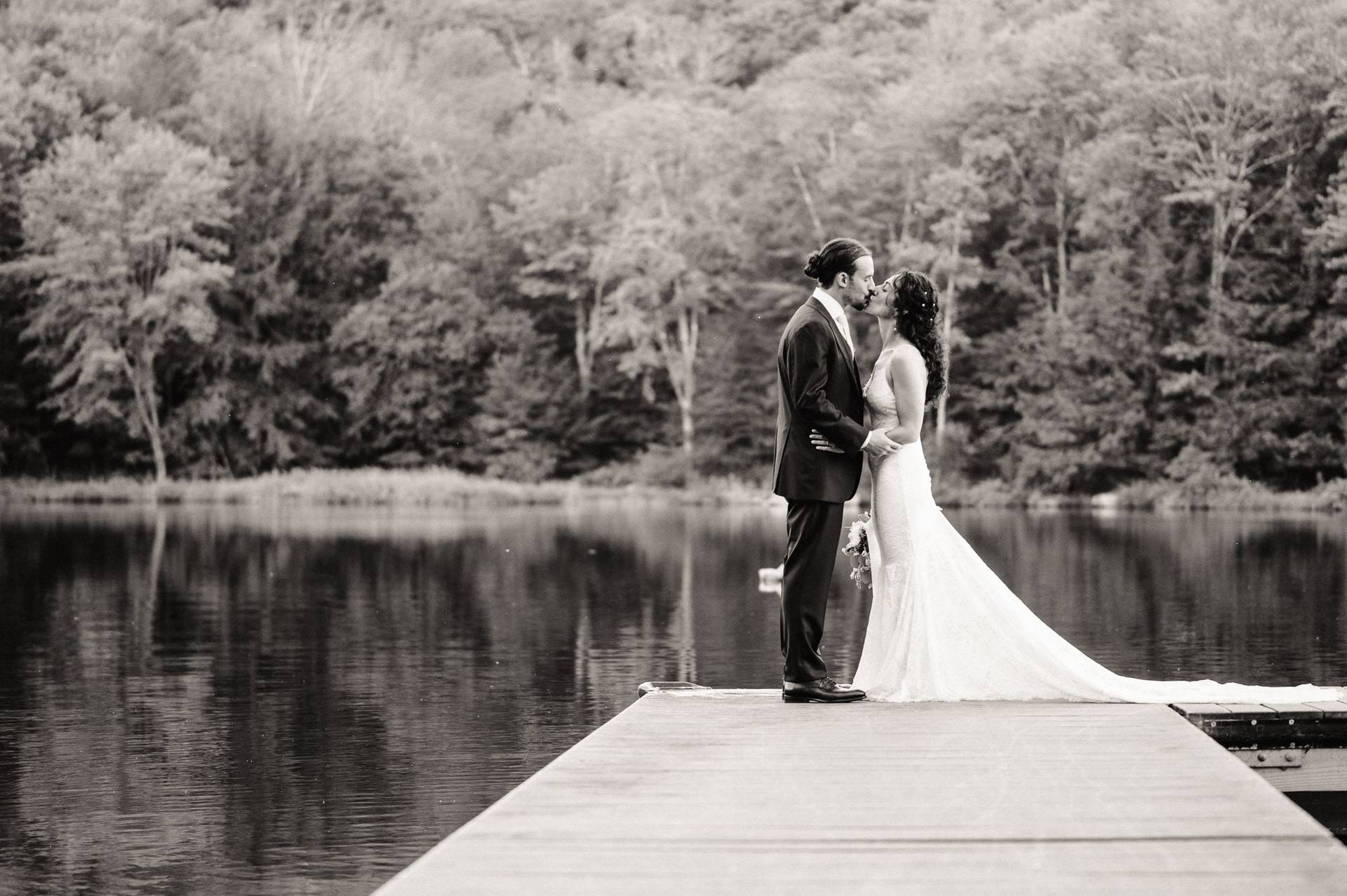 Misty lake and couple at the end of the dock