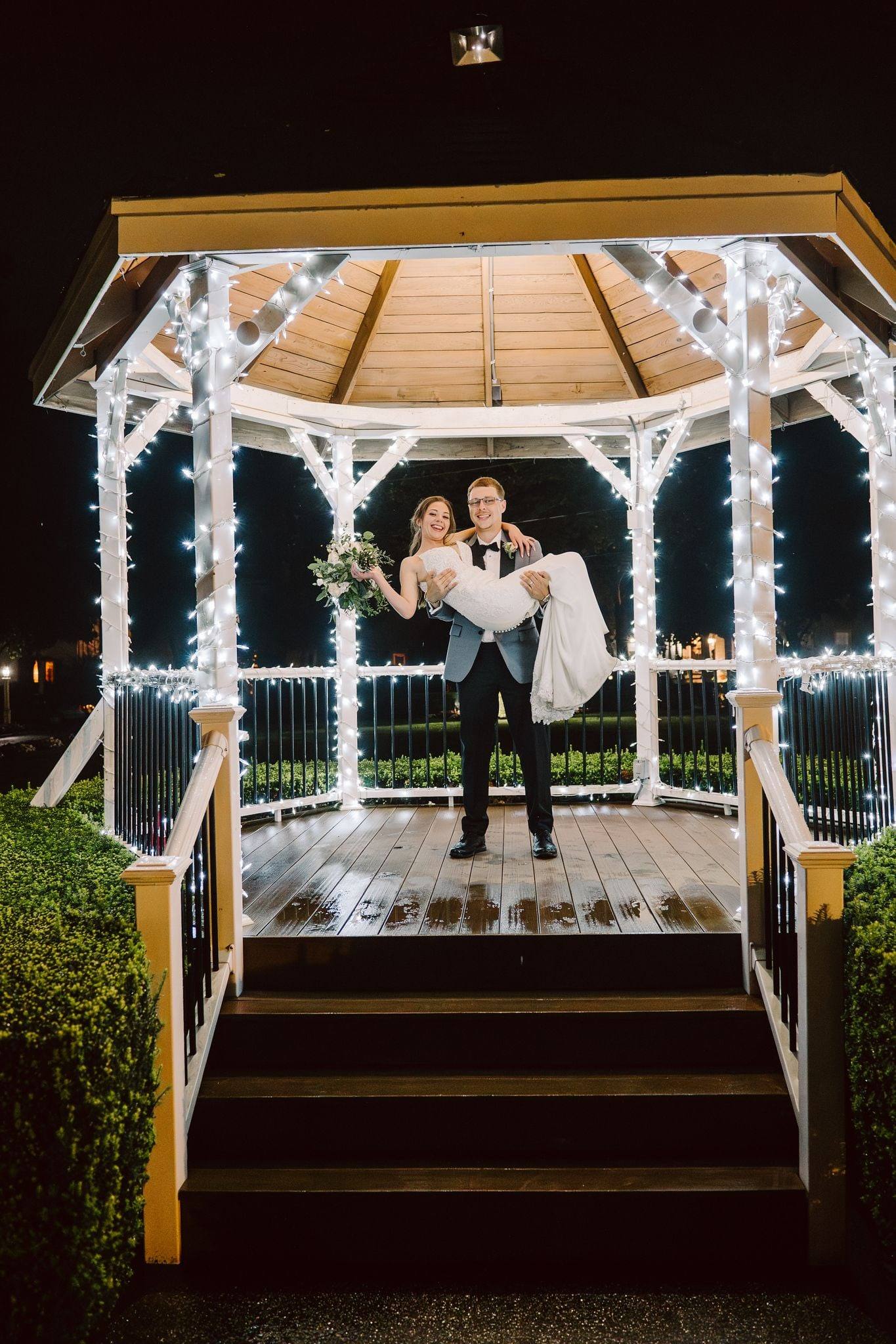 Embrace in a string-lit gazebo at night