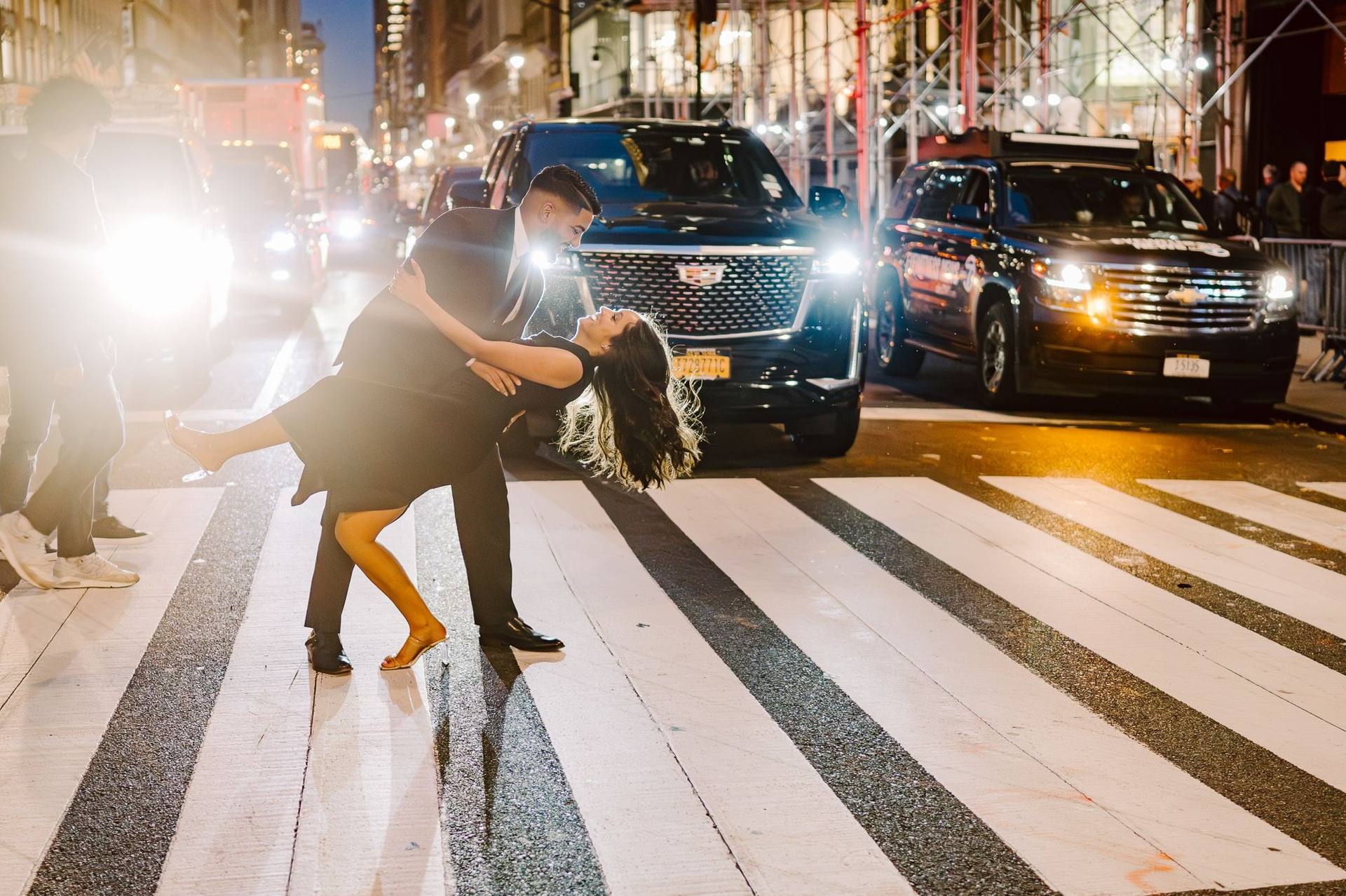 Night crosswalk dip lit by headlights