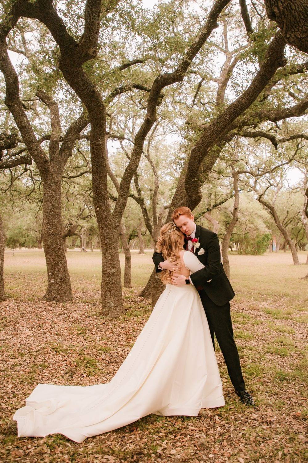 Couple among the oaks in autumn light