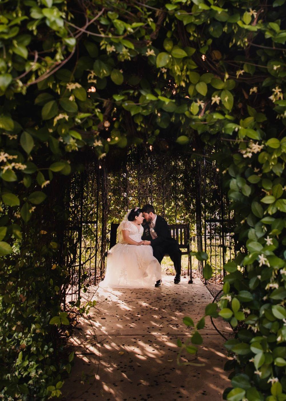 Sweetheart table beneath a garden arbor