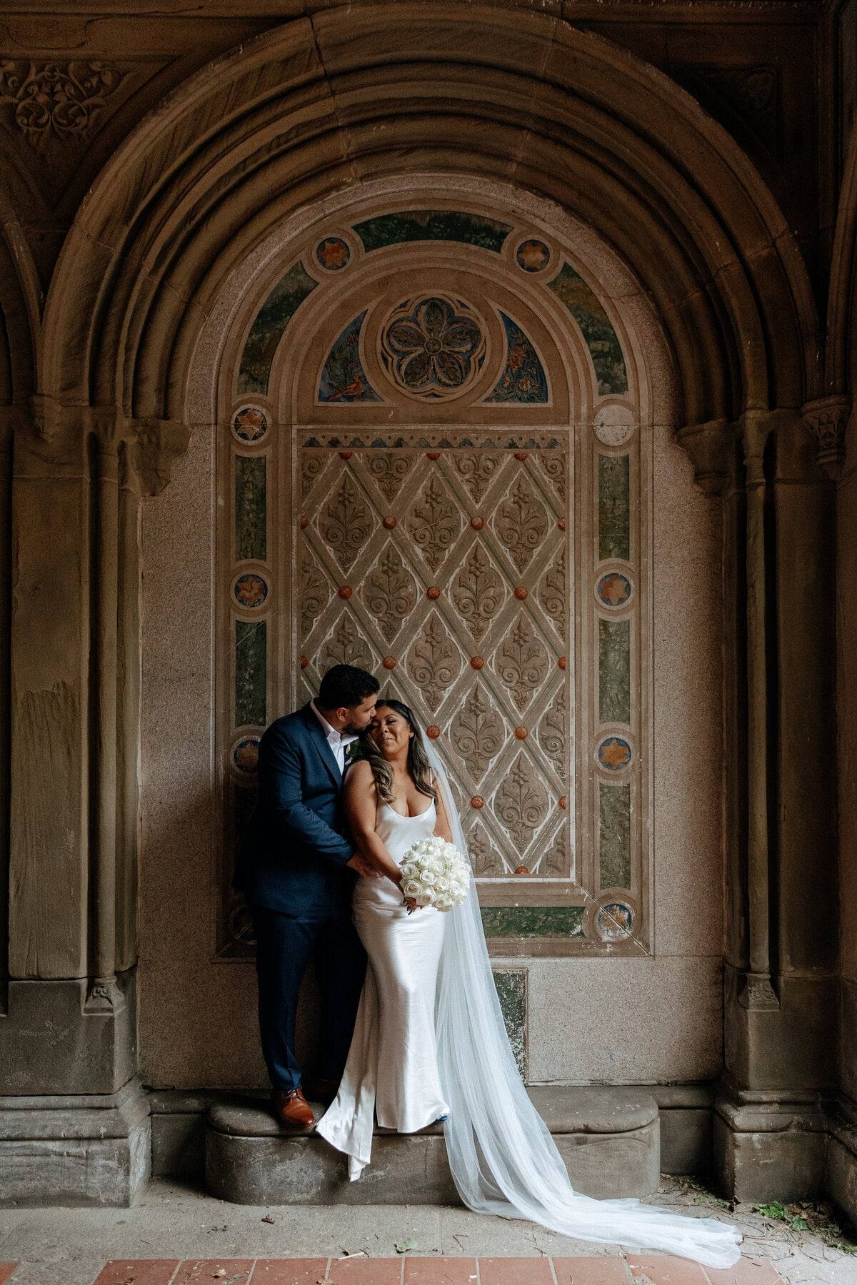 Couple beneath an ornate stone arch