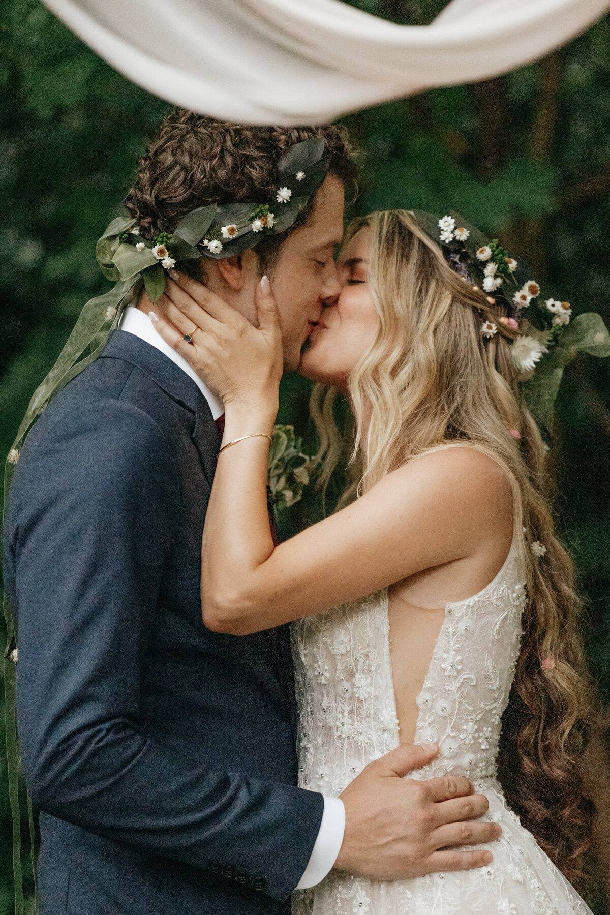 Flower-crown kiss in the forest