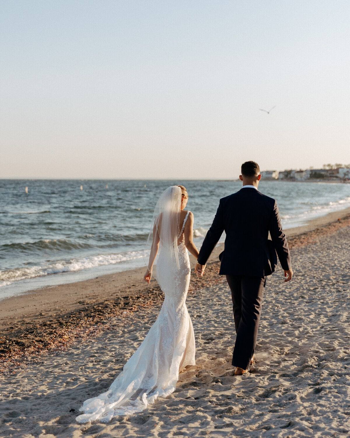 Beach walk at sunset, gown trailing