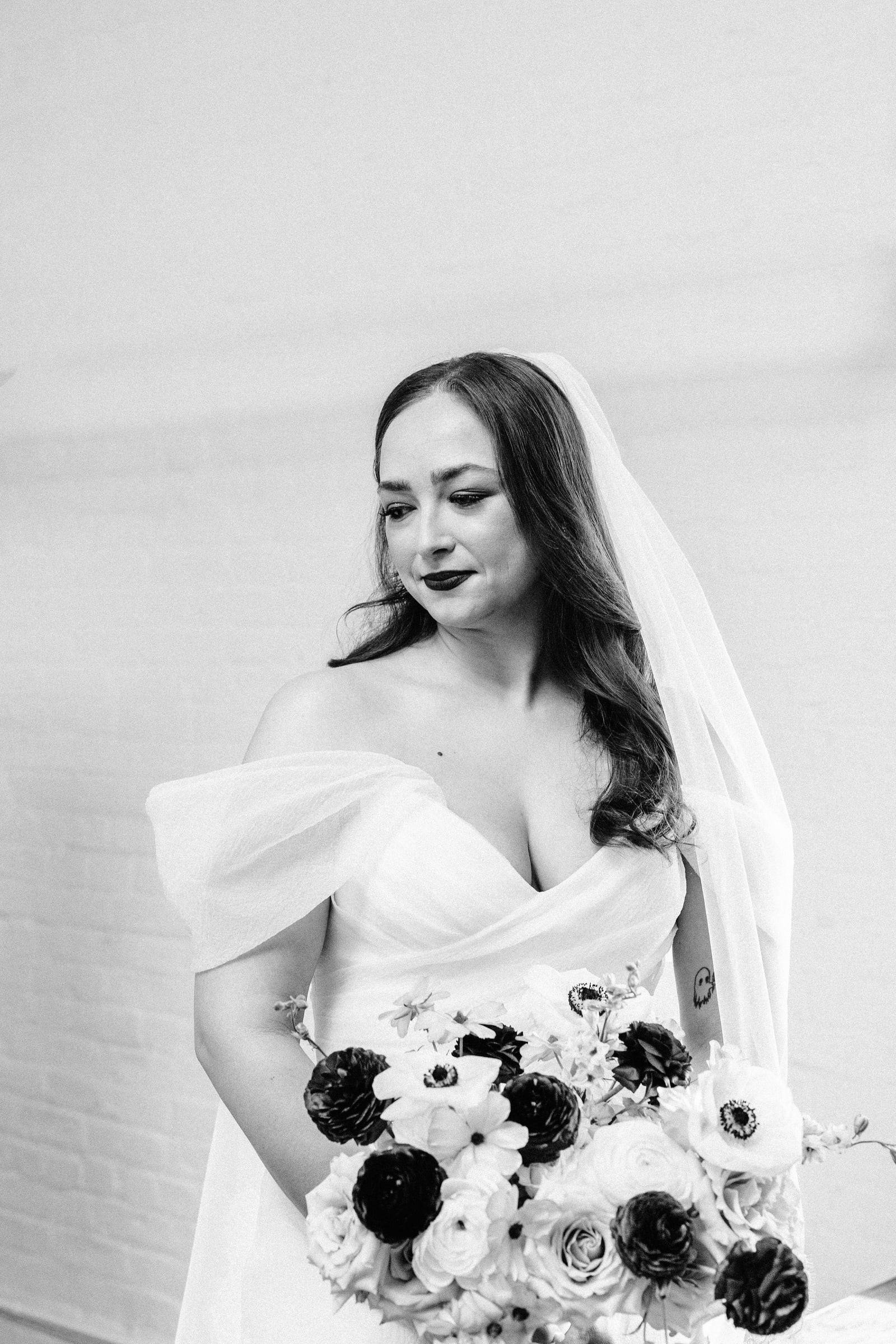 Black and white bridal portrait with anemone bouquet