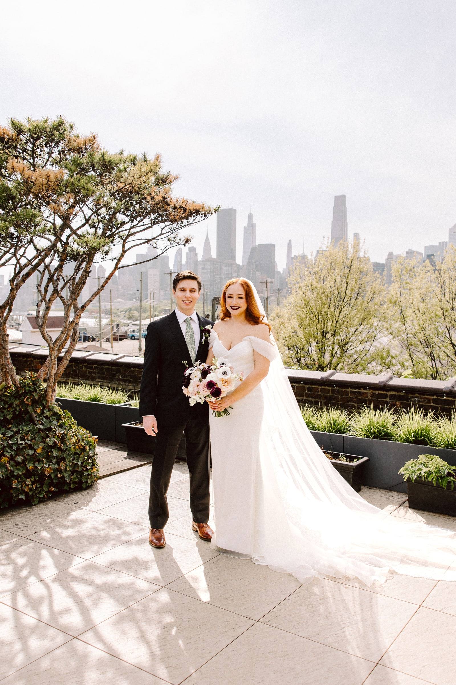 Rooftop stroll with gown train fanned against the skyline