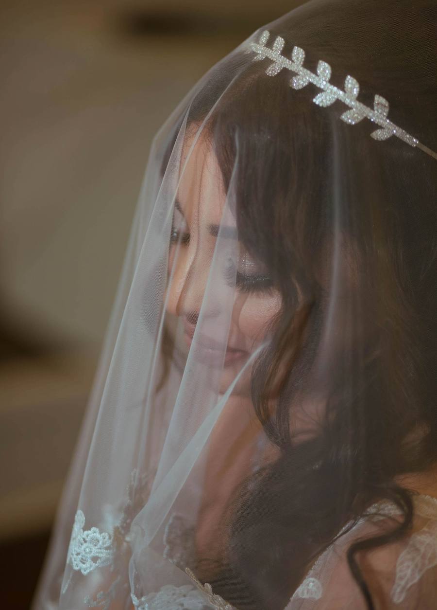 Bride in a pearl crown, veiled profile
