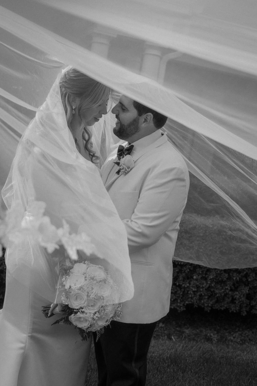 Veil-wrapped kiss in the desert
