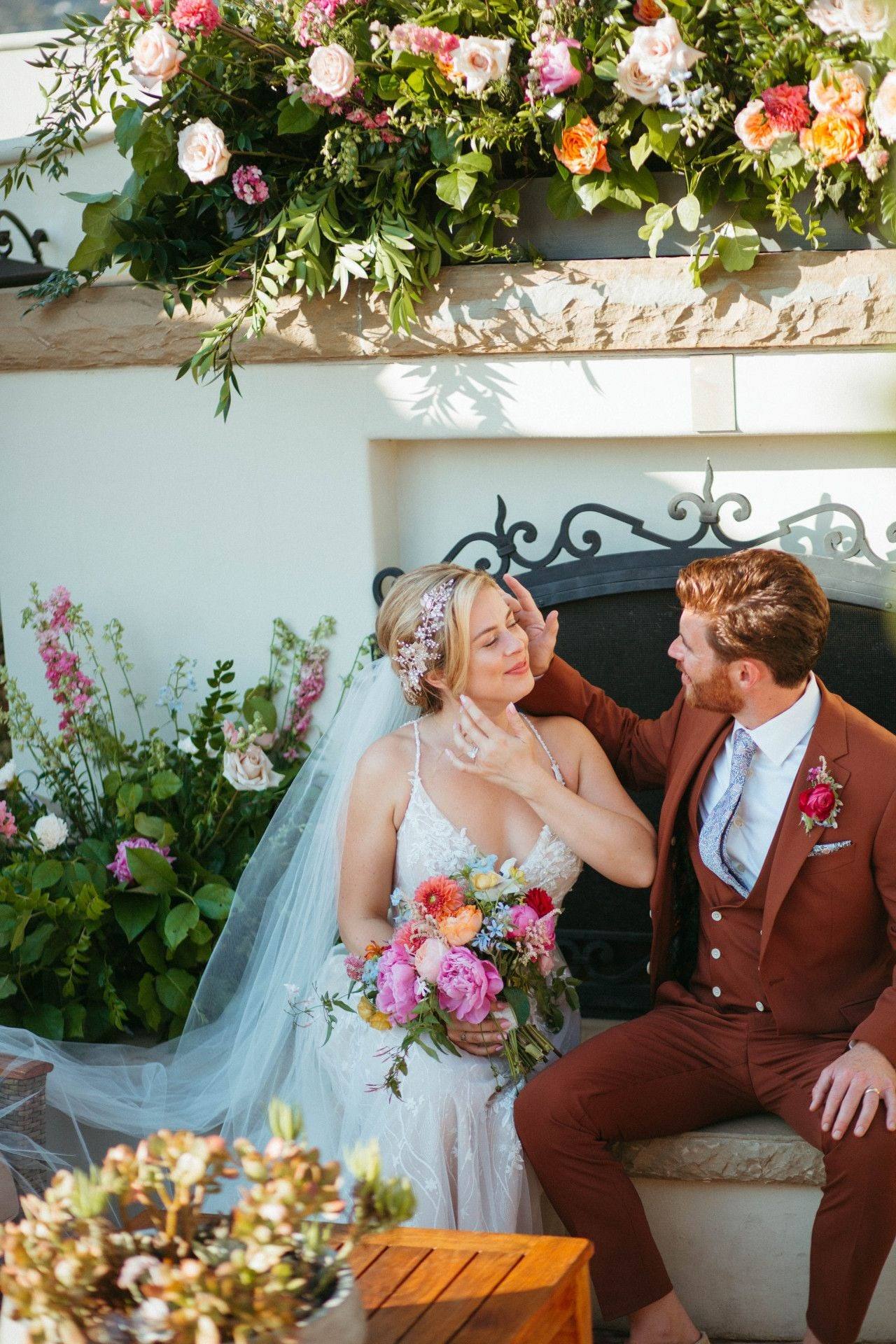 Couple at the flower-decked mantel