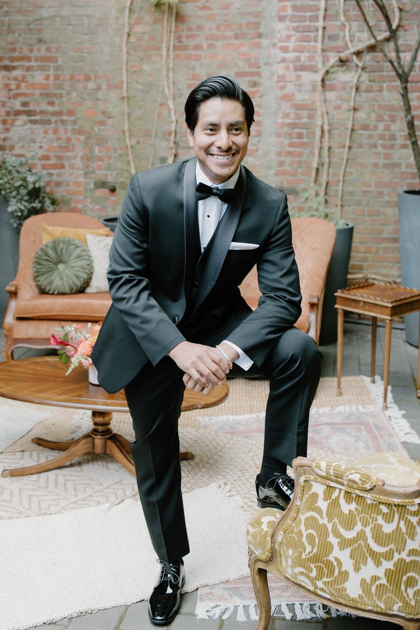 Groom seated in a velvet chair