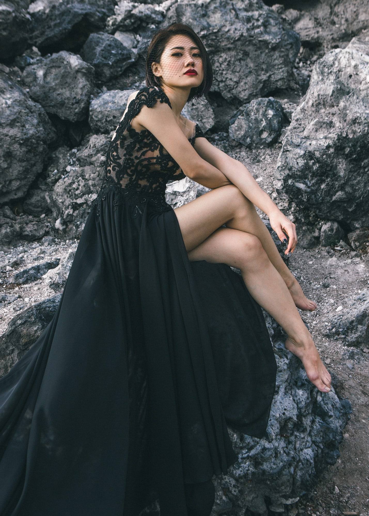 Editorial black gown on the rocks