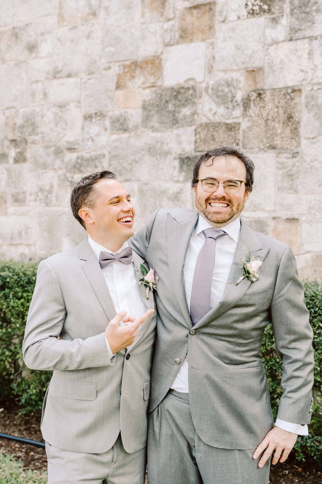 Two grooms laughing together