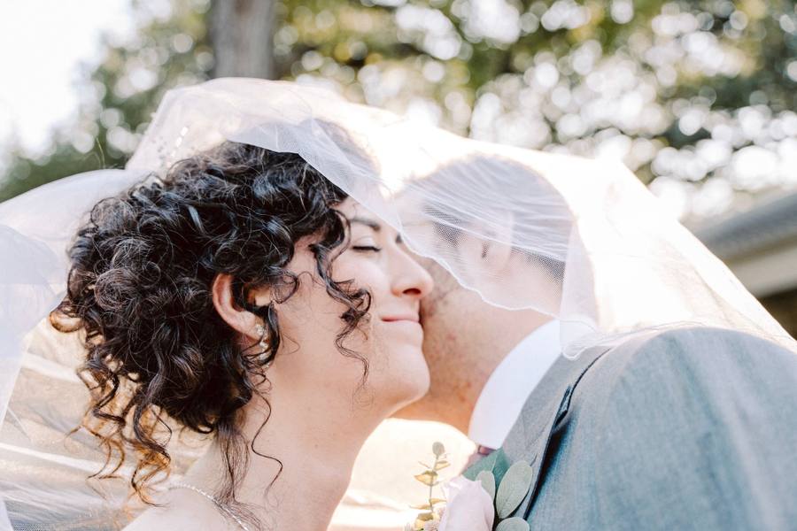 Veil-wrapped close-up kiss