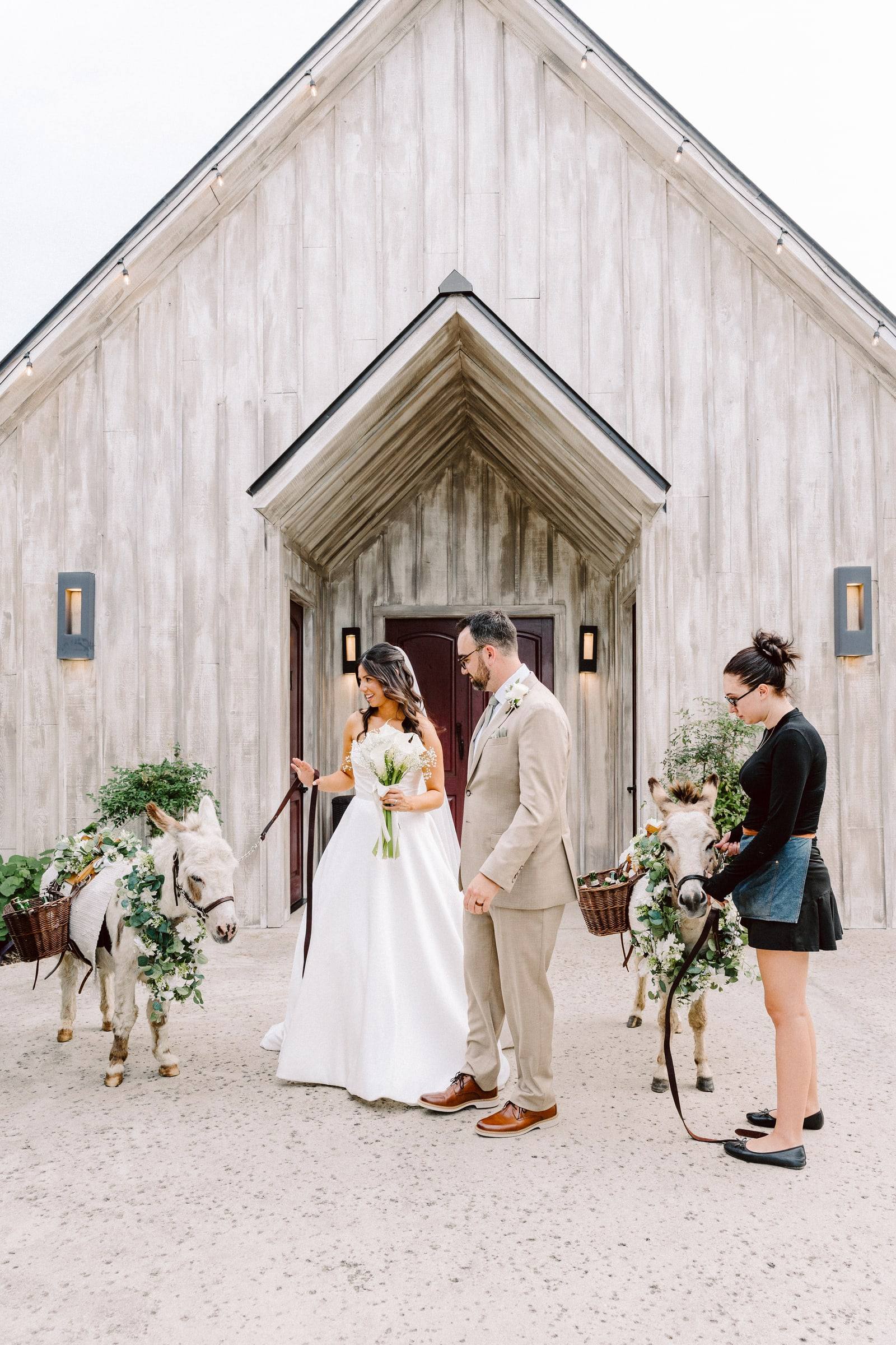 Couple with garlanded ponies at a chapel