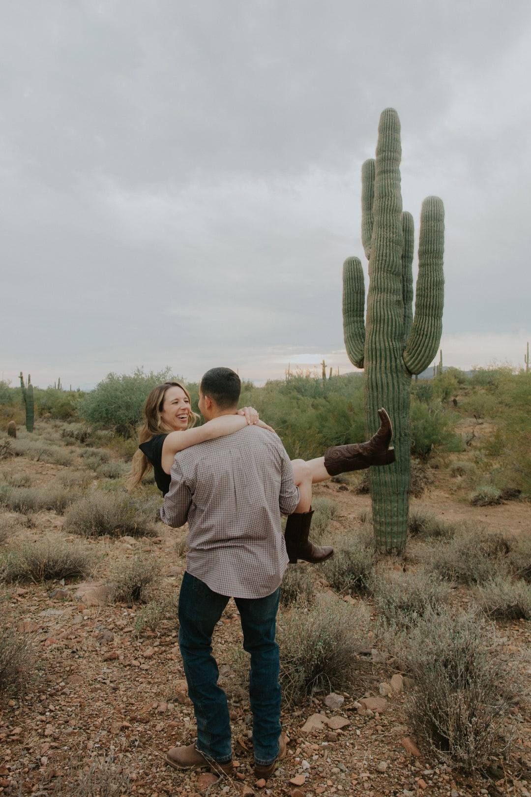Desert engagement beneath a saguaro