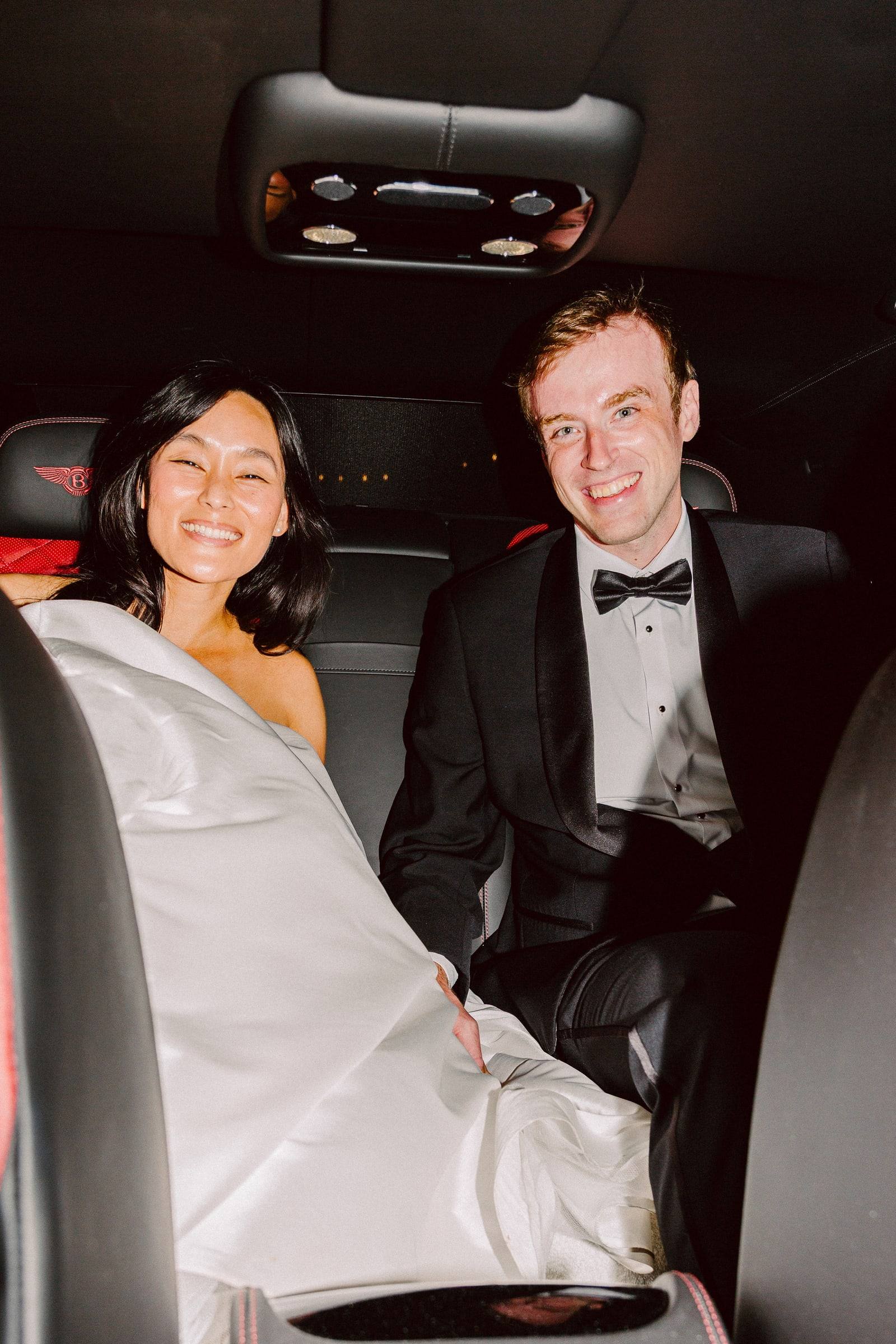 Beaming bride in the getaway car