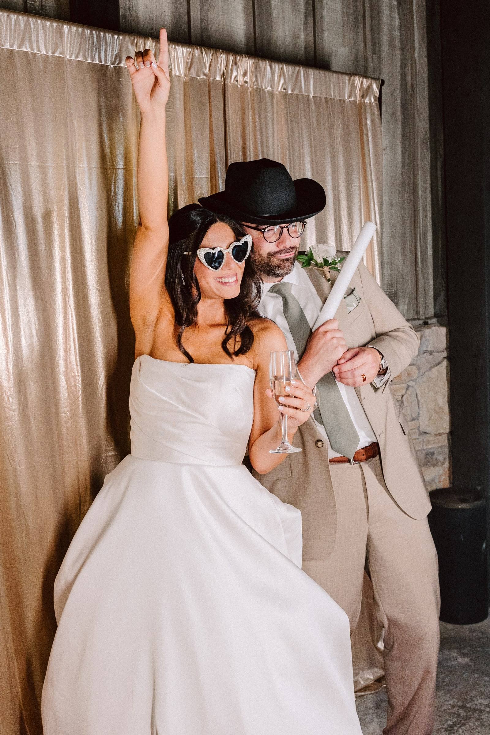 Playful photobooth moment in a cowboy hat